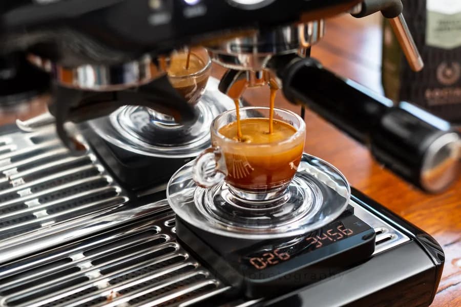 Espresso being pulled into a cup on a scale
