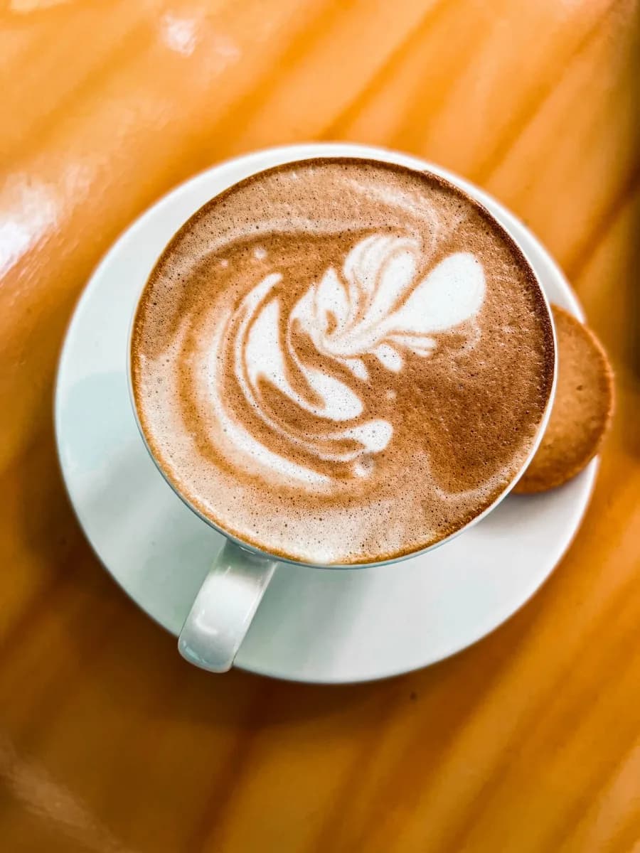 Served cappuccino on a wooden table